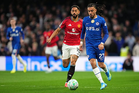 Chelsea's Malo Gusto, right, and Manchester United's Matheus Cunha challenge for the ball during the English Premier League soccer match between Chelsea and Manchester United in London.