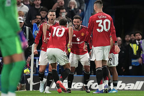 Manchester United's Matheus Cunha celebrates with teammates after scoring the opening goal during the English Premier League soccer match between Chelsea and Manchester United in London.