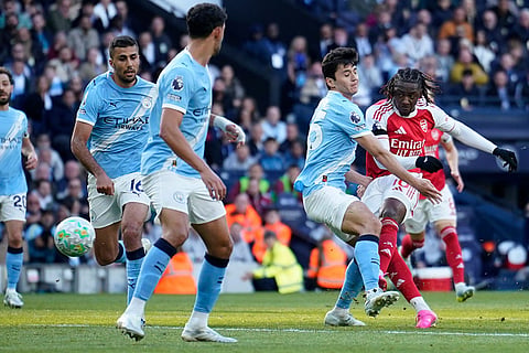 Arsenal's Eberechi Eze shoots and hits the bar during the English Premier League soccer match between Manchester City and and Arsenal, in Manchester, England.
