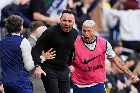 Tottenham Hotspur manager Roberto De Zerbi and Richarlison celebrate their first goal on the touchline during their English Premier League soccer match against Brighton & Hove Albion in London.