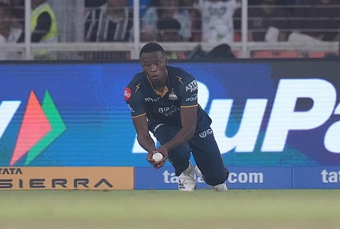 Gujarat Titans' Kagiso Rabada takes the catch to dismiss Mumbai Indians' Naman Dhir during the Indian Premier League cricket match between Gujarat Titans and Mumbai Indians in Ahmedabad.