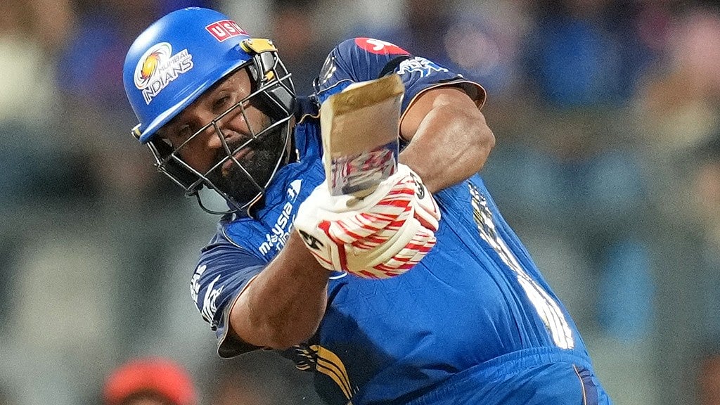 AP/Rafiq Maqbool : Rohit Sharma plays a shot during the Indian Premier League match between Mumbai Indians and Royal Challengers Bengaluru, in Mumbai.