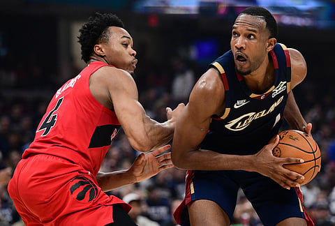 Cleveland Cavaliers center Evan Mobley goes tot he basket against Toronto Raptors forward Scottie Barnes during the second half in Game 1 of a first-round NBA playoffs basketball series, in Cleveland.