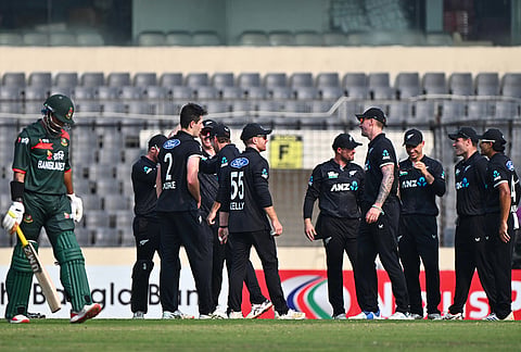 New Zealand cricketers celebrate the wicket of Bangladesh's Najmul Hossain Shanto, left, during the second one day international cricket match between Bangladesh and New Zealand in Mirpur, Bangladesh.