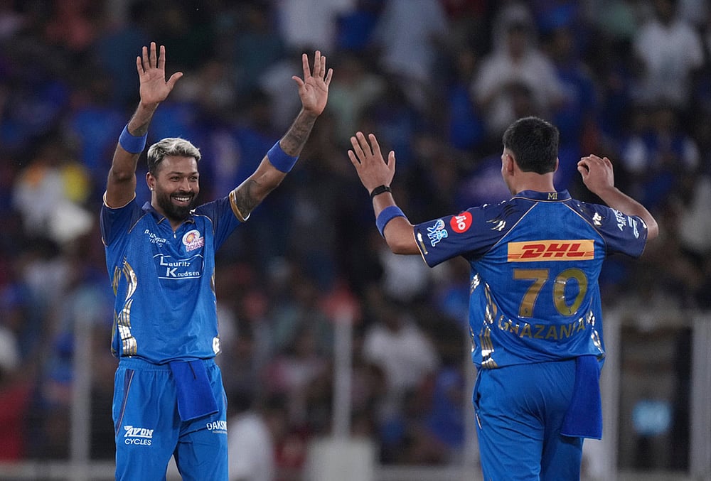 | Photo: AP/Ajit Solanki : Mumbai Indians' captain Hardik Pandya, left, celebrates after winning the match the Indian Premier League cricket match against Gujarat Titans in Ahmedabad.
