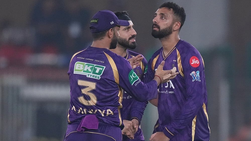 Kolkata Knight Riders' Varun Chakaravarthy, right, celebrates with teammates the wicket of Gujarat Titans' Jos Buttler during the Indian Premier League cricket match between Gujarat Titans and Kolkata Knight Riders in Ahmedabad. - | Photo: AP/Ajit Solanki