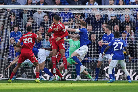 Liverpool's Virgil van Dijk (4) scores his side's 2nd goal during the English Premier League soccer match between Everton and Liverpool in Liverpool, England.