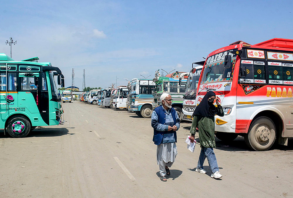 | Photo: PTI : People walk past a bus stand after driver and conductors of private buses stage a protest against the government's proposal to expand Smart City bus services in other districts, in Srinagar, Jammu and Kashmir.