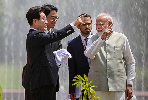 Prime Minister Narendra Modi and South Korean President Lee Jae Myung plant a sapling, at Hyderabad House in New Delhi.