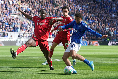 Liverpool's Ibrahima Konate, left, tries block a shot by Everton's Iliman Ndiaye during the English Premier League soccer match between Everton and Liverpool in Liverpool, England.