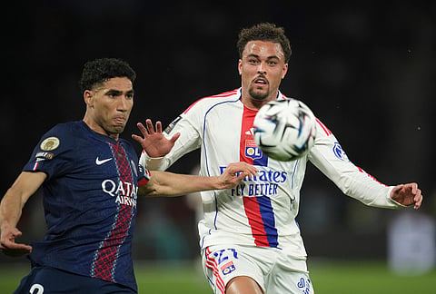 PSG's Achraf Hakimi, left, and Lyon's Ruben Kluivert challenge for the ball during the French League One soccer match between Paris Saint-Germain and Olympique Lyon in Paris, France.