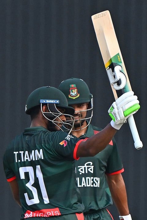 Bangladesh's Tanzid Hasan Tamim raised his bat to celebrate fifty runs during the second one day international cricket match between Bangladesh and New Zealand in Mirpur, Bangladesh.