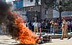Source:  PTI : Flames billow as a police bike is set ablaze by factory workers during a protest demanding a hike in wages, in Noida, Gautam Buddh Nagar district, Uttar Pradesh, Monday, April 13, 2026. The protest carried incidents of arson, vandalism and stone-pelting reported from Phase-2 and Sector 60 areas, police said.