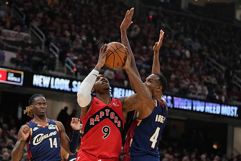 Toronto Raptors forward RJ Barrett (9) goes to the basket between Cleveland Cavaliers guard Keon Ellis (14) and center Evan Mobley (4) in the first half in Game 2 of a first-round NBA basketball playoffs series in Cleveland.