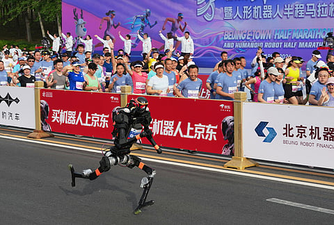A robot starts off for the Beijing E-Town Half Marathon and Humanoid Half Marathon on the outskirts of Beijing.