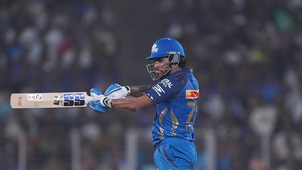 Mumbai Indians' Tilak Verma hits a six during the Indian Premier League cricket match between Gujarat Titans and Mumbai Indians in Ahmedabad. - | Photo: AP/Ajit Solanki