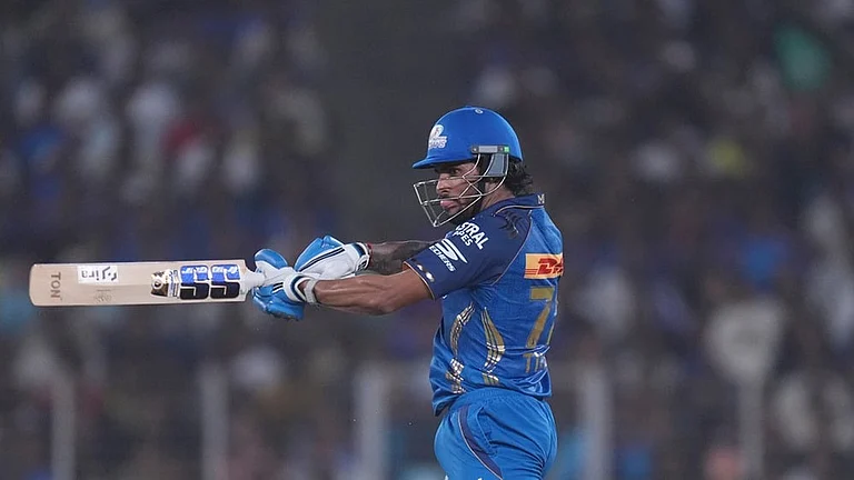 Mumbai Indians' Tilak Verma hits a six during the Indian Premier League cricket match between Gujarat Titans and Mumbai Indians in Ahmedabad. - | Photo: AP/Ajit Solanki