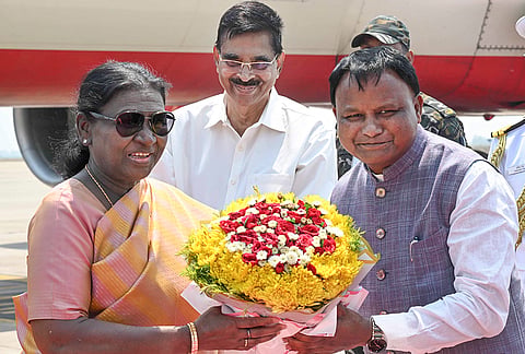 President Droupadi Murmu being received by Odisha Chief Minister Mohan Charan Majhi, right, upon her arrival, in Jharsuguda district, Odisha. State Governor Hari Babu Kambhampati, centre, is also present. 