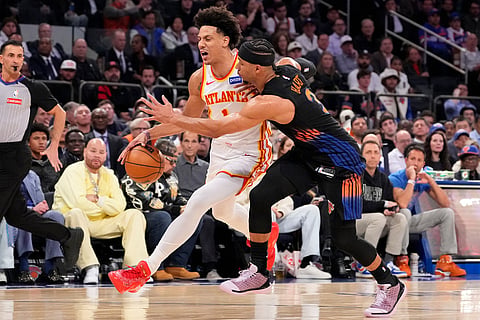Atlanta Hawks forward Jalen Johnson, center left, drives past New York Knicks guard Josh Hart, center right, during the second half in Game 2 of a first-round NBA playoffs basketball series in New York.