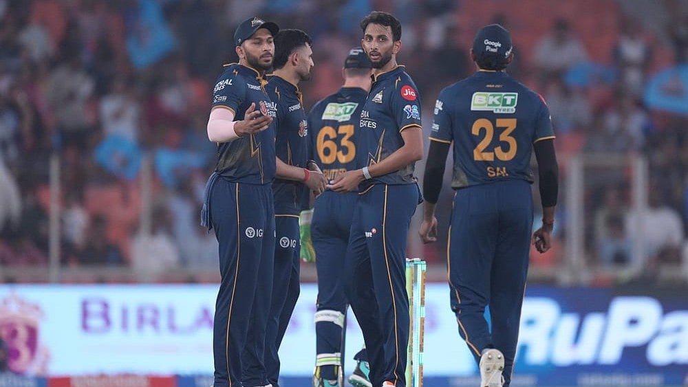 Gujarat Titans' Prasidh Krishna, centre, celebrates with teammates the wicket of Mumbai Indians' Naman Dhir during the Indian Premier League cricket match between Gujarat Titans and Mumbai Indians in Ahmedabad. - | Photo: AP/Ajit Solanki