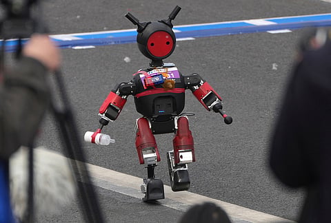 A robot resembling a toddler with a milk bottle starts off for the Beijing E-Town Half Marathon and Humanoid Half Marathon held on the outskirts of Beijing.