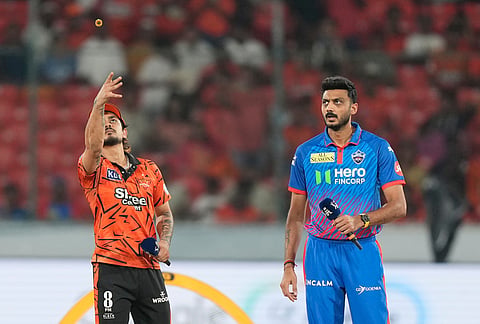 Sunrisers Hyderabad's captain Ishan Kishan, left, toss the coin as Delhi Capitals' captain Axar Patel, watch it during the Indian Premier League cricket match between Sunrisers Hyderabad and Delhi Capitals in Hyderabad.