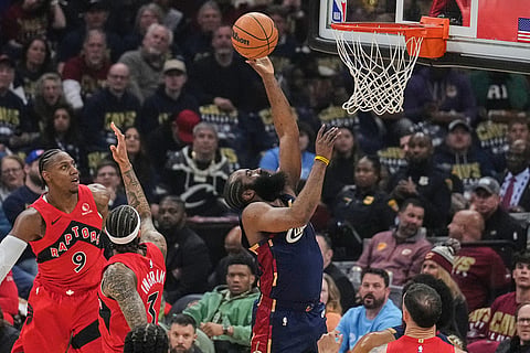 Cleveland Cavaliers guard James Harden, right, goes to the basket past Toronto Raptors forward RJ Barrett (9) and forward Brandon Ingram (3) in the first half in Game 2 of a first-round NBA basketball playoffs series in Cleveland.