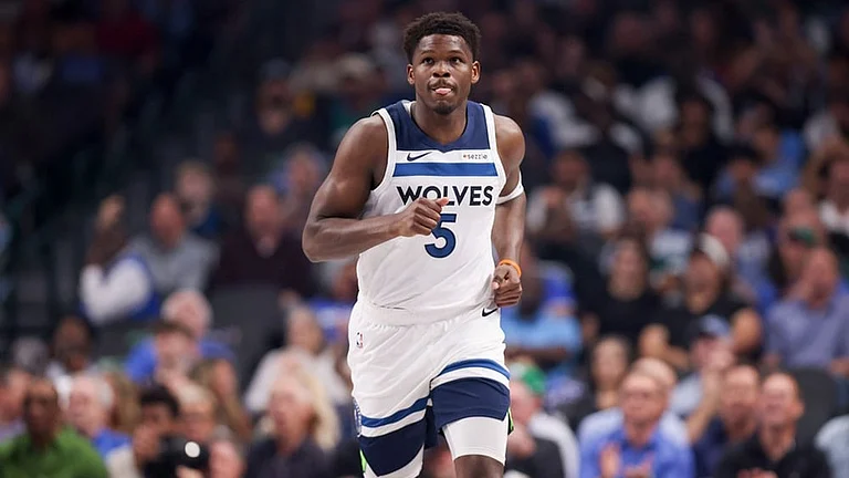 Minnesota Timberwolves guard Anthony Edwards runs the court before an NBA basketball game against the Dallas Mavericks, in Dallas. - | Photo: AP/Gareth Patterson
