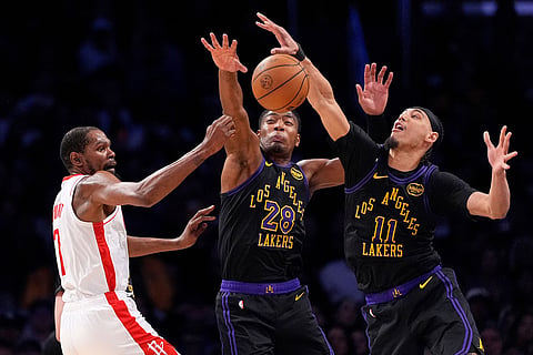 Houston Rockets forward Kevin Durant, left, passes as Los Angeles Lakers forward Rui Hachimura, center, and center Jaxson Hayes defend during the second half in Game 2 of a first-round NBA playoffs basketball series in Los Angeles.