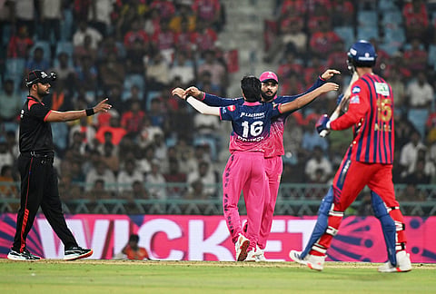 Rajasthan Royals' Brijesh Sharma, center, back to the camera, celebrates with captain Riyan Parag the wicket of Lucknow Super Giants' Mukul Choudhary, right, during the Indian Premier League cricket match between Lucknow Super Giants and Rajasthan Royals in Lucknow.