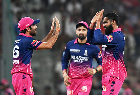 Rajasthan Royals' Ravindra Jadeja, right, celebrates with teammate Ravi Bishnoi the wicket of Lucknow Super Giants' Nicholas Pooran during the Indian Premier League cricket match between Lucknow Super Giants and Rajasthan Royals in Lucknow.