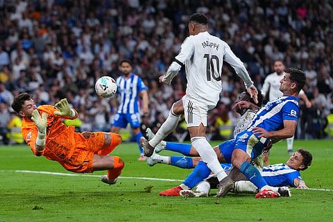 Alaves' goalkeeper Antonio Sivera saves in front oof Real Madrid's Kylian Mbappe during a La Liga soccer match between Real Madrid and Alaves in Madrid, Spain.
