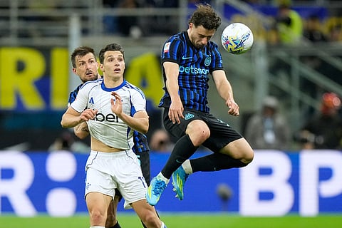 Inter Milan's Carlos Augusto, right, heads the ball besides Como's Anastasios Douvikas during the Italian Cup, return-leg soccer match between Inter Milan and Como, in Milan, Italy.