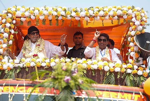 Bollywood actor and BJP leader Mithun Chakraborty greets supporters during a roadshow in support of the party's candidate Samarendranath Ghosh, on the eve of the West Bengal Assembly elections, at Karimpur, in Nadia district.