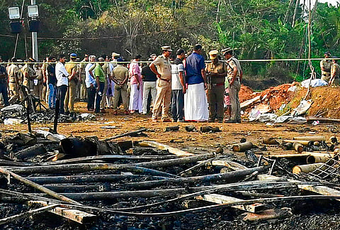 Police personnel cordon off an area as they investigate the site after a blast at a fireworks manufacturing unit at Mundathicode, in Thrissur district, Kerala.