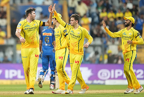 Chennai Super Kings' Jamie Overton, left, celebrates with teammates the wicket of Mumbai Indians' Krish Bhagat during the Indian Premier League cricket match between Mumbai Indians and Chennai Super Kings in Mumbai.