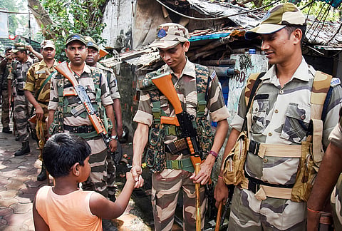 Paramilitary forces conduct a march past near the Kalighat Kali Temple at Rashbehari Assembly constituency, for the upcoming West Bengal Assembly elections, in Kolkata.