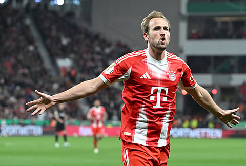 Bayern's Harry Kane, right (9) celebrates scoring the opening goal during the German Soccer Cup semifinal match between Bayer Leverkusen and Bayern Munich in Leverkusen, Germany.