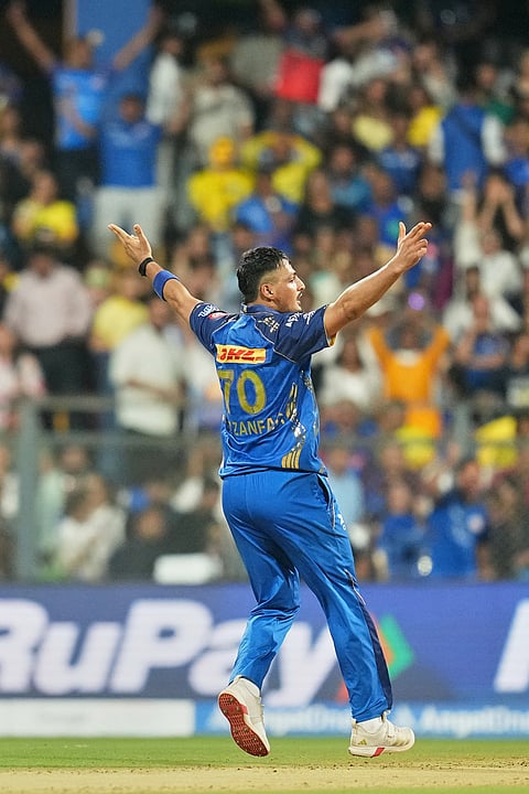 Mumbai Indians' Allah Ghazanfar celebrates the wicket of Chennai Super Kings' Shivam Dube during the Indian Premier League cricket match between Mumbai Indians and Chennai Super Kings in Mumbai.