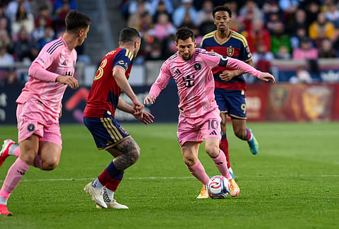 Inter Miami midfielder Lionel Messi (10) controls the ball as he works through the defense of Real Salt Lake defender Alexandros Katranis, center left, during an MLS soccer match, in Sandy, Utah.
