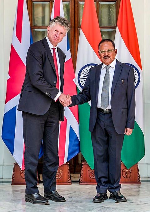 National Security Advisor Ajit Doval, right, meets his UK counterpart Jonathan Powell during the annual India-UK Strategic Dialogue, in New Delhi. 