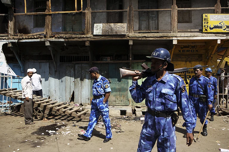 September 2008, Malegaon Shopkeeper monitoring losses property commandoes with Action Force keeping vigil after the bomb blast on 29th - PTI