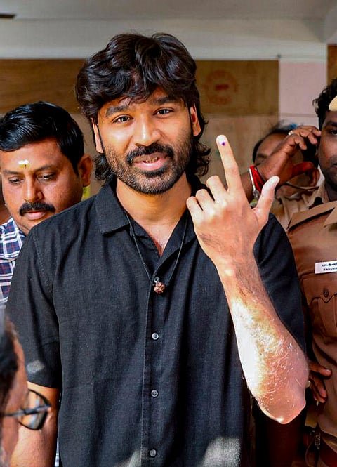 Actor Dhanush shows his ink-marked finger after casting a vote in the Tamil Nadu Assembly elections, at a polling station in Chennai.