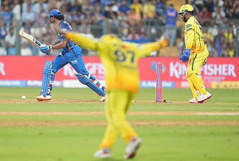 Mumbai Indians' Tilak Varma bowled out by Chennai Super Kings' Akeal Hosein during the Indian Premier League cricket match between Mumbai Indians and Chennai Super Kings in Mumbai.