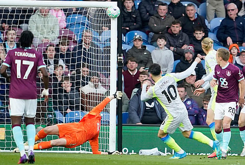 Manchester City's Rayan Cherki hits the post during the Premier League soccer match between Burnley and Manchester City in Burnley, England.