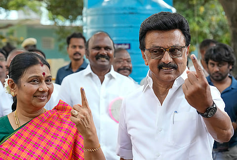 Tamil Nadu Chief Minister and DMK candidate from Kolathur constituency, MK Stalin, right, with his wife Durga Stalin shows his ink-marked finger after casting a vote in the state Assembly elections, at a polling station, in Chennai.