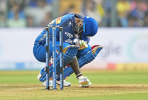 Mumbai Indians' Suryakumar Yadav reacts after hitting by a ball during the Indian Premier League cricket match between Mumbai Indians and Chennai Super Kings in Mumbai.