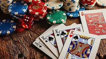 Poker chips, dice, and a winning hand of three Kings