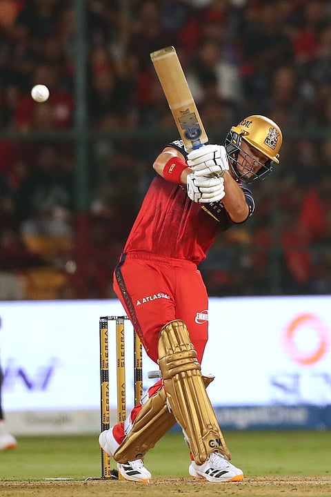 Royal Challengers Bengaluru's Jacob Bethell hits a boundary during the Indian Premier League cricket match between Royal Challengers Bengaluru and Gujarat Titans in Bengaluru.