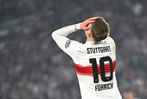 Stuttgart's Chris Fuehrich reacts after missing a scoring chance during a German Cup semifinal soccer match between VfB Stuttgart and SC Freiburg, in Stuttgart, Germany. 